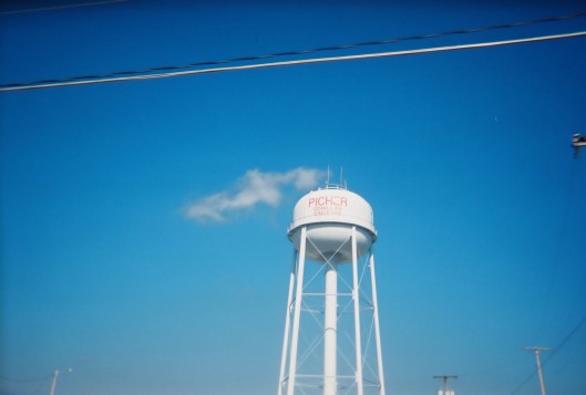 Picher's water tower under a blue sky.